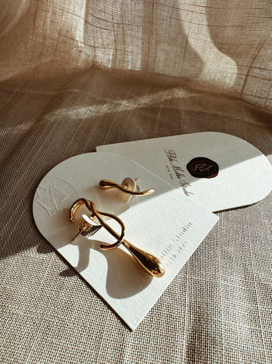 Gold-plated sterling silver drop earrings with uneven design