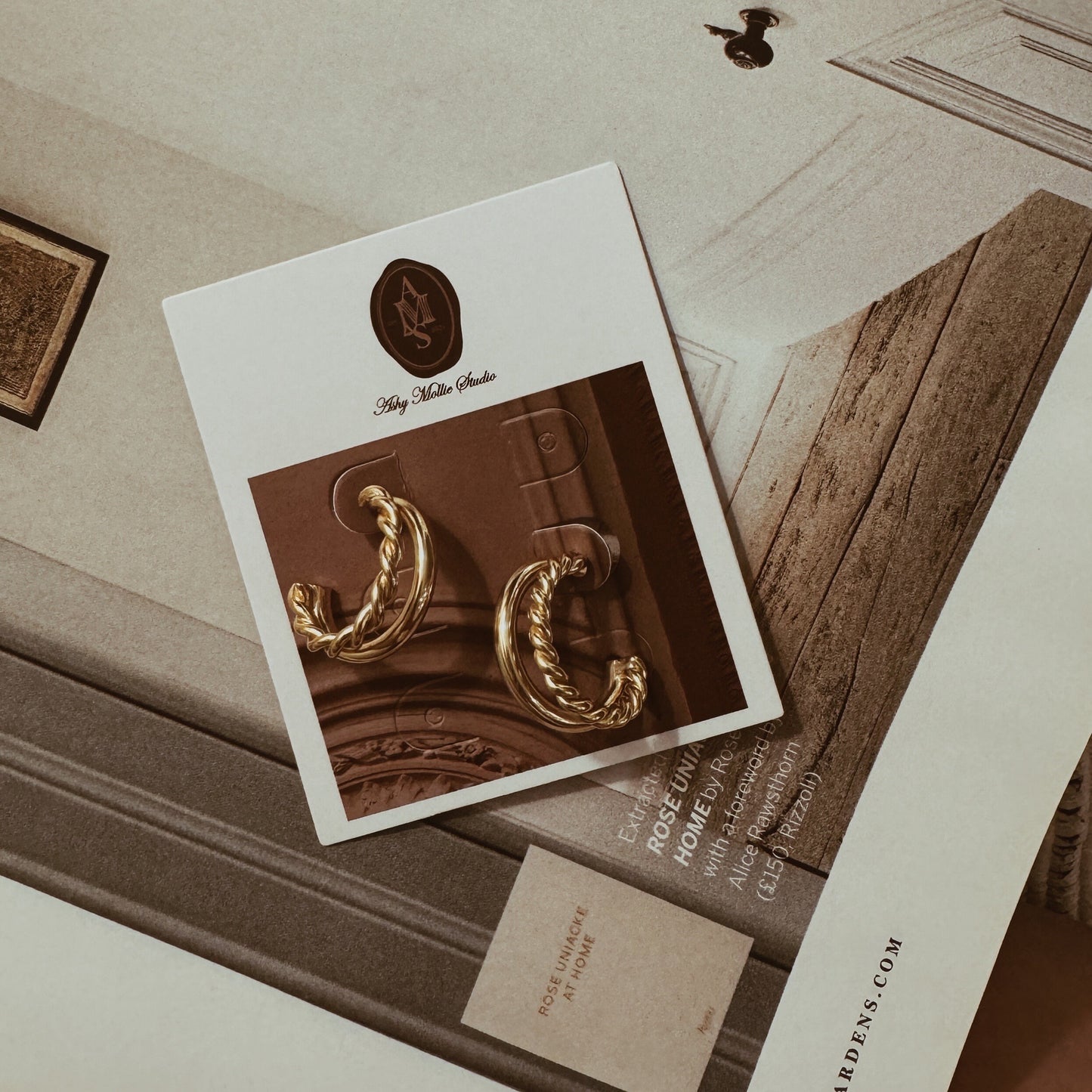 Gold twisted double hoop earrings with a braided design