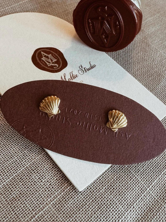 Gold-plated shell earrings with a minimalist design