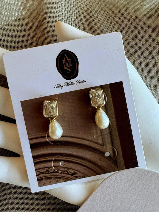 Gold-plated pearl earrings with gemstone detail