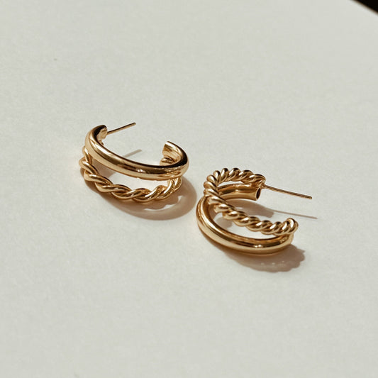 Gold twisted double hoop earrings with a braided design