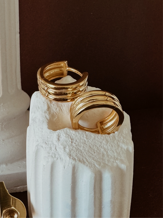 Small gold hoop earrings with ribbed texture and triple hoop design